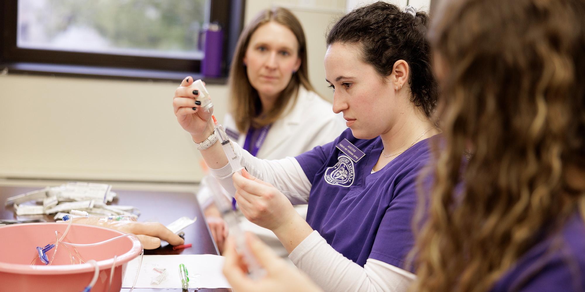 Undergraduate Nursing Students In Classroom With Teacher